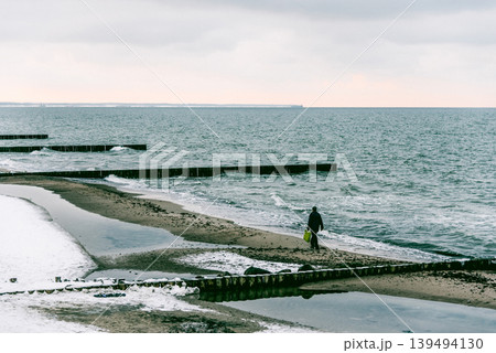 Winter seascape, splash wave crashing on breakwater, natural sea landscape Winter seascape, splash wave crashing on breakwater, natural sea landscape 139494130
