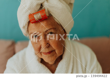 Senior woman with hair wrapped in a towel after shower. Senior woman with hair wrapped in a towel after shower. 139494422