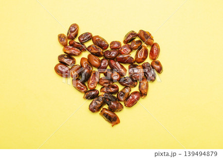 Dates forming heart on yellow background for healthy love 139494879