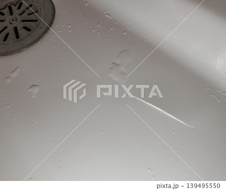 Broken Acrylic Bathtub with Visible Crack and Moisture Broken Acrylic Bathtub with Visible Crack and Moisture 139495550