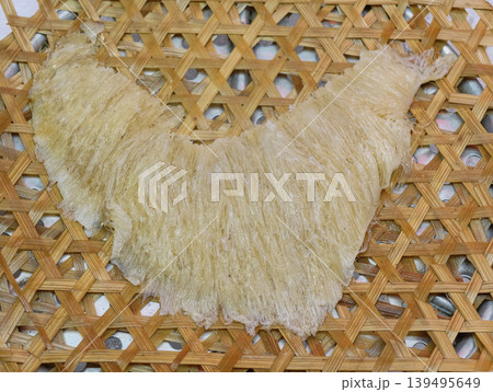 Premium dried shark fin delicacy on traditional bamboo tray 139495649