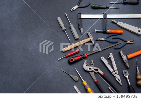 Equipment implements. Assortment of Hand Tools on Dark Background Equipment implements. Assortment of Hand Tools on Dark Background 139495738