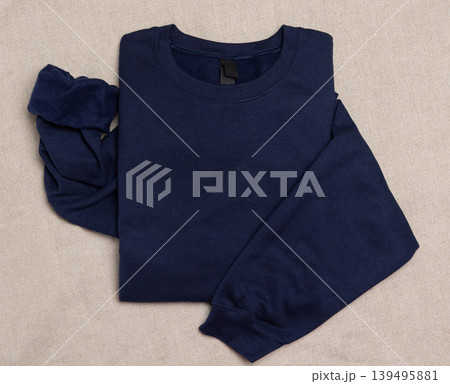 Blank navy blue unisex sweatshirt mockup, folded flat lay with copy space on front and sleeve Blank navy blue unisex sweatshirt mockup, folded flat lay with copy space on front and sleeve 139495881