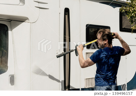 Man washing residential motorhome with pressure washer near private house in summer. 139496157