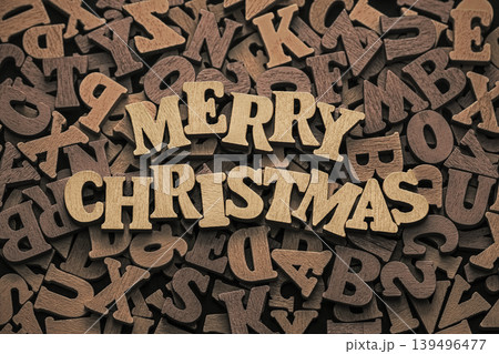 Inscription Merry Christmas on pile of old vintage wooden letters. Holiday concept. Inscription Merry Christmas on pile of old vintage wooden letters. Holiday concept. 139496477
