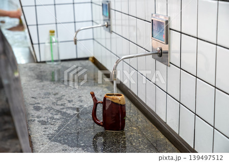 Pouring coffee at the counter Pouring coffee at the counter 139497512
