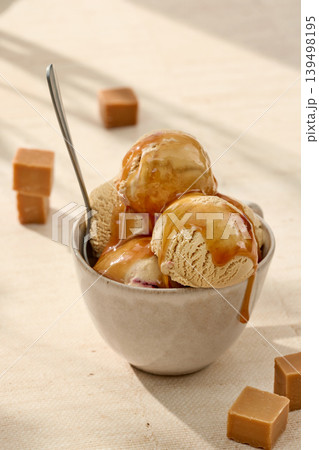 Caramel gelato ice cream with caramel sauce in bowl Caramel gelato ice cream with caramel sauce in bowl 139498195