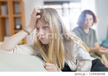 Teen girl feeling upset after disagreement with mother Teen girl feeling upset after disagreement with mother 139498496