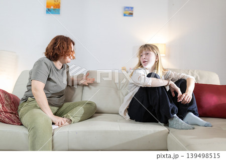 Mother and daughter having important conversation in living room 139498515