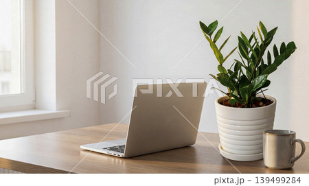 laptop with plant on wooden table laptop with plant on wooden table 139499284