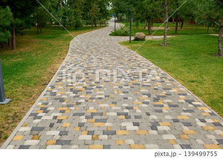 Winding paved path through the park. Winding paved path through the park. 139499755