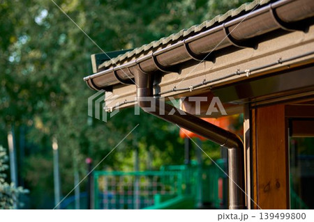 Roof line with brown gutters and wood soffit Roof line with brown gutters and wood soffit 139499800
