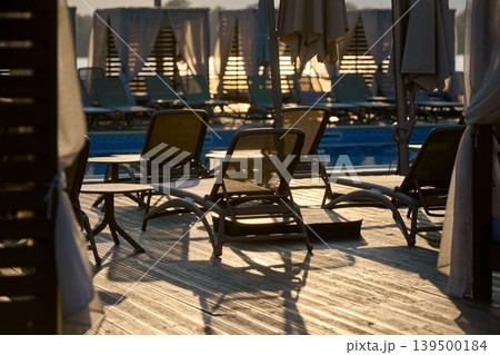 Sunset reflections by the serene poolside Sunset reflections by the serene poolside 139500184
