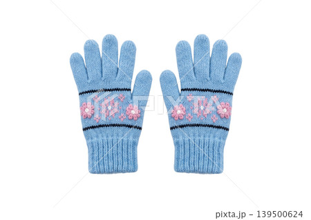 Blue knitted winter gloves with pink floral embroidery isolated Blue knitted winter gloves with pink floral embroidery isolated 139500624