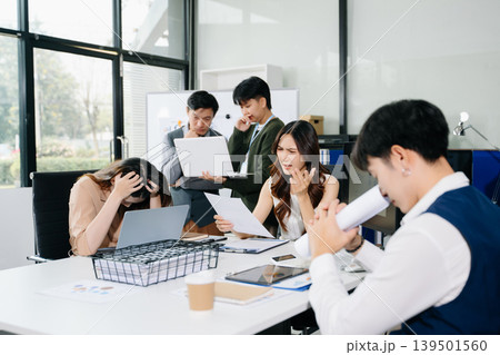 Stressed business team dealing with problem and deadline pressure in office meeting, showing conflict, frustration, and workplace challenges 139501560