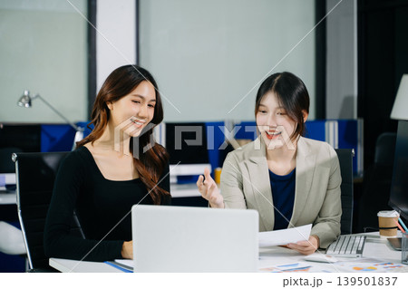 Asian women working together in a startup office, mentoring and collaboration with digital tools to boost productivity, workflow, and business success 139501837
