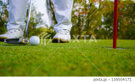 Golfers are putting golf in the evening golf course golf backglound. 139504171