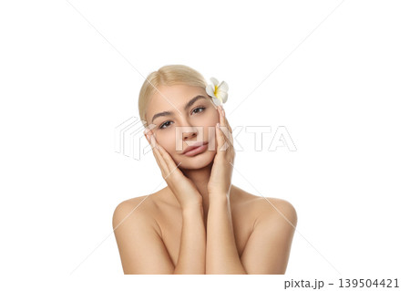 Woman uses gentle skincare, flower in hair, isolated on white, PNG Woman uses gentle skincare, flower in hair, isolated on white, PNG 139504421