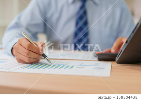 Asian Male 30-40s Real Estate Agent Analyzing Market Charts in Thailand Office Asian Male 30-40s Real Estate Agent Analyzing Market Charts in Thailand Office 139504438