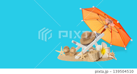 Orange parasol with beach items on sandy surface during summer Orange parasol with beach items on sandy surface during summer 139504510