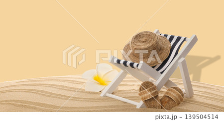 Beach chair with striped fabric and straw hat resting on sand Beach chair with striped fabric and straw hat resting on sand 139504514