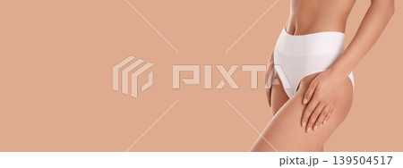 Woman prioritizes skincare and body confidence on beige background Woman prioritizes skincare and body confidence on beige background 139504517