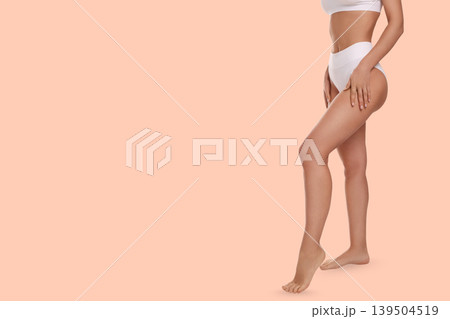 Person highlights their toned legs in a relaxed manner Person highlights their toned legs in a relaxed manner 139504519