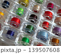 Colorful spools of sewing and embroidery thread in plastic organizers. Vibrant threads and craft supplies for needlework projects 139507608