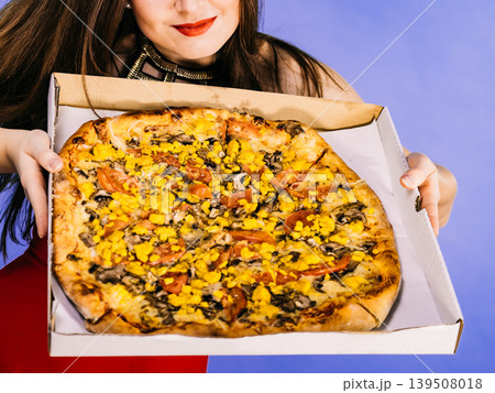 Woman holding big pizza in box Woman holding big pizza in box 139508018