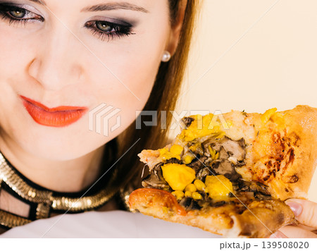 Woman eating hot pizza slice Woman eating hot pizza slice 139508020