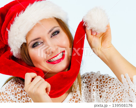 Joyful woman in christmas santa hat Joyful woman in christmas santa hat 139508176