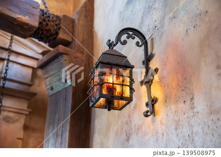 Antique lamp light up attached on historic castle wall 139508975