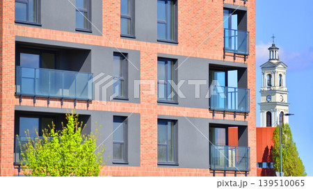 European residential architecture harmonizing with nature. Eco-friendly living in city with greens. Eco apartment building saving energy and fresh air concept. European residential architecture harmonizing with nature. Eco-friendly living in city with greens. Eco apartment building saving energy and fresh air concept. 139510065