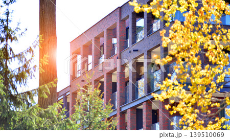 European residential architecture harmonizing with nature. Eco-friendly living in city with greens. Eco apartment building saving energy and fresh air concept.  139510069