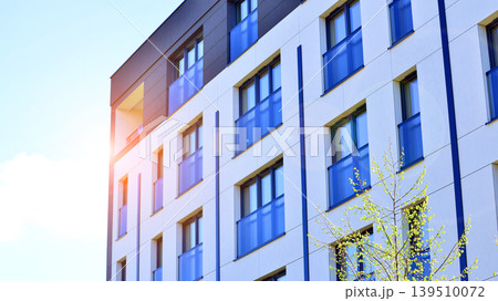 European residential architecture harmonizing with nature. Eco-friendly living in city with greens. Eco apartment building saving energy and fresh air concept. European residential architecture harmonizing with nature. Eco-friendly living in city with greens. Eco apartment building saving energy and fresh air concept. 139510072