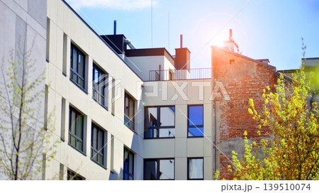 European residential architecture harmonizing with nature. Eco-friendly living in city with greens. Eco apartment building saving energy and fresh air concept. European residential architecture harmonizing with nature. Eco-friendly living in city with greens. Eco apartment building saving energy and fresh air concept. 139510074