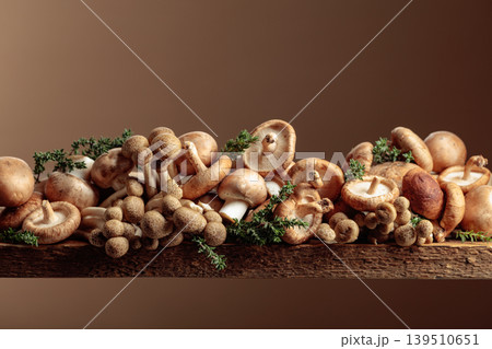 An assortment of mushrooms on a rustic wooden board with sprigs of thyme. An assortment of mushrooms on a rustic wooden board with sprigs of thyme. 139510651