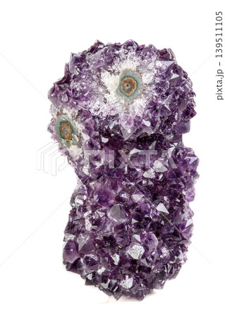 Macro mineral stone Amethyst eye, in the form of an owl on a white background Macro mineral stone Amethyst eye, in the form of an owl on a white background 139511105