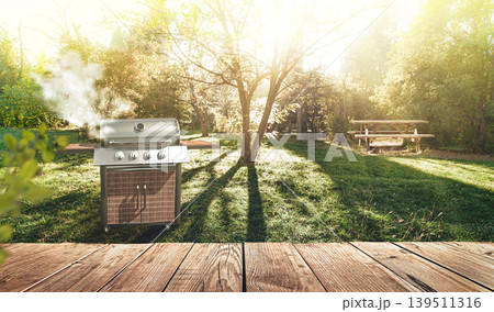 summer time in backyard garden with grill BBQ, wooden table, blurred background 139511316