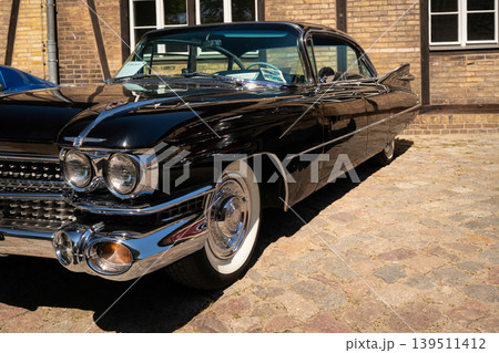 Berlin, Germany - May 2, 2026. Classic black Cadillac on cobblestone Berlin, Germany - May 2, 2026. Classic black Cadillac on cobblestone 139511412