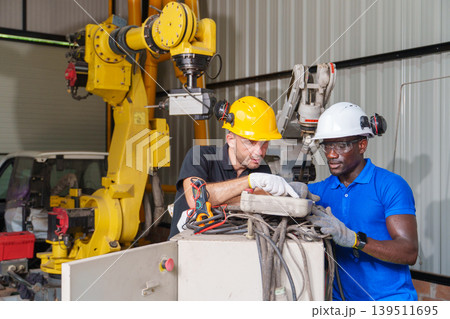 Diverse Engineering Team 20-40s Troubleshooting Robotic Systems Diverse Engineering Team 20-40s Troubleshooting Robotic Systems 139511695