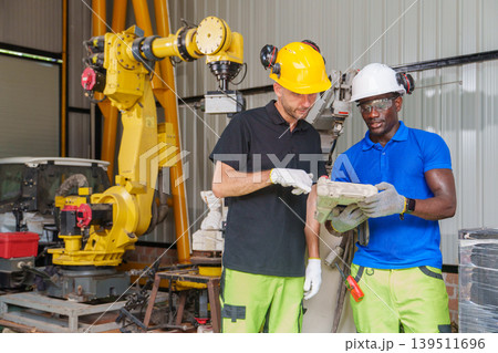 Diverse Engineering Team 20-40s Troubleshooting Robotic Systems Diverse Engineering Team 20-40s Troubleshooting Robotic Systems 139511696