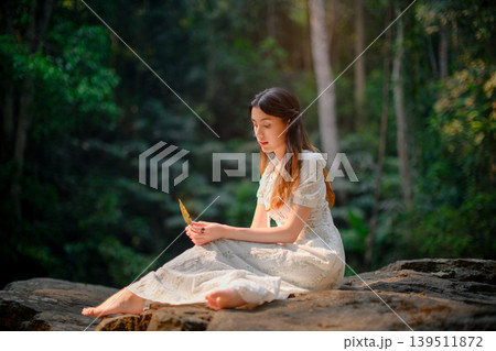 beautiful woman in white dress in deep forest, elf princess fairy tale concept beautiful woman in white dress in deep forest, elf princess fairy tale concept 139511872