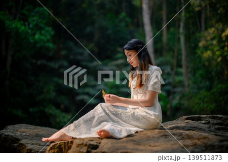 beautiful woman in white dress in deep forest, elf princess fairy tale concept beautiful woman in white dress in deep forest, elf princess fairy tale concept 139511873