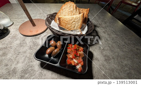 Appetizer toast with fresh tomato salsa and olives 139513001