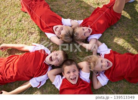 Children, soccer team and portrait with smile, boys and girls with high angle, support or solidarity. Energy, sports and friendship, together and happy for win, ready for game and physical activity Children, soccer team and portrait with smile, boys and girls with high angle, support or solidarity. Energy, sports and friendship, together and happy for win, ready for game and physical activity 139513349