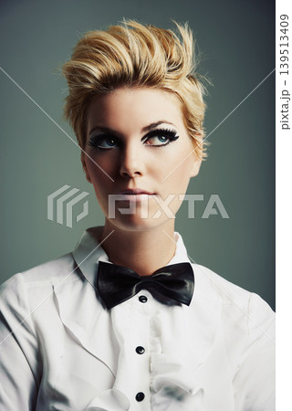 Thinking, bow tie or woman with fashion, ideas or vintage clothes on grey background in studio. Classy aesthetic, edgy female model or confident girl isolated with retro style, beauty and cool makeup Thinking, bow tie or woman with fashion, ideas or vintage clothes on grey background in studio. Classy aesthetic, edgy female model or confident girl isolated with retro style, beauty and cool makeup 139513409