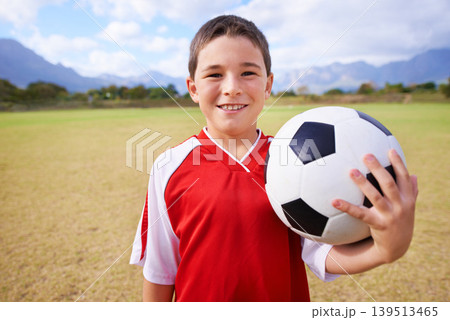 Child, portrait and soccer player on field, sports and confidence for match and game. Happy boy, face and ready for competition in outdoors, smiling and practice or training for skills on grass 139513465