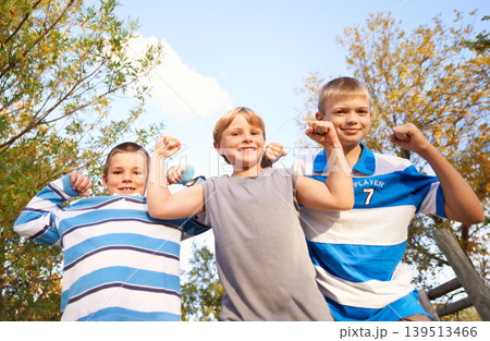 Happy children, portrait and flexing muscles at park for fun day, holiday or weekend together in nature. Face of young kids or friends smile for outdoor summer break, bonding or youth on playground Happy children, portrait and flexing muscles at park for fun day, holiday or weekend together in nature. Face of young kids or friends smile for outdoor summer break, bonding or youth on playground 139513466