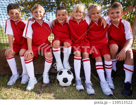 Kids, soccer team and portrait with ball, boys and girls with players, support or solidarity. Energy, sports and friendship, together and happy for win, ready for game or physical activity 139513522